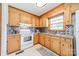 Cozy kitchen featuring wooden cabinets, modern backsplash and tile flooring with modern appliances at 1188 Rainbow Cir, Catawba, SC 29704