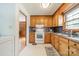 Cozy kitchen featuring wooden cabinets, modern backsplash and tile flooring with modern appliances at 1188 Rainbow Cir, Catawba, SC 29704