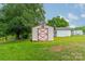 Well-maintained storage shed with red trim, offering practical storage solutions in a spacious backyard at 1188 Rainbow Cir, Catawba, SC 29704