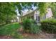 Landscaped backyard featuring lush greenery, mature trees, and a well-maintained lawn at 119 Ashwood Ln, Mooresville, NC 28117
