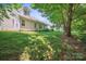 Landscaped backyard featuring mature trees and lush green lawn at 119 Ashwood Ln, Mooresville, NC 28117