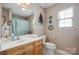 Bathroom with a white countertop, double sinks, toilet, and decorative accents at 119 Ashwood Ln, Mooresville, NC 28117