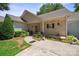 Charming single-story home with a covered porch, landscaped flower beds, and inviting curb appeal at 119 Ashwood Ln, Mooresville, NC 28117