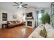 Spacious living room boasts vaulted ceilings, brick fireplace, ceiling fan, wood flooring and comfortable seating at 119 Ashwood Ln, Mooresville, NC 28117