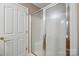 Clean shower with glass door is located next to an adjacent door in a bathroom at 119 Ashwood Ln, Mooresville, NC 28117