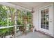 Bright sunroom features expansive windows, glass shelving and door to outside, perfect for displaying plants and decor at 119 Ashwood Ln, Mooresville, NC 28117