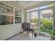 Relaxing sunroom provides a serene spot with comfortable seating and views of the outdoor landscape at 119 Ashwood Ln, Mooresville, NC 28117