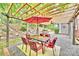 Backyard patio beneath a pergola includes a table, chairs, and a view of a landscaped hillside at 1230 Somersby Ln, Matthews, NC 28105