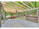 A covered patio provides outdoor living space with table, chairs, and a view of the landscaped yard at 1230 Somersby Ln, Matthews, NC 28105