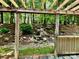 Beautiful backyard featuring a wooden pergola and landscaped hillside with natural stone details at 1230 Somersby Ln, Matthews, NC 28105
