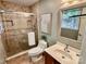 Bathroom with tiled shower, toilet, vanity and framed mirror with a decorative plant at 1230 Somersby Ln, Matthews, NC 28105