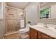 Bathroom featuring a tiled shower with glass door, a toilet, and vanity with a mirror at 1230 Somersby Ln, Matthews, NC 28105
