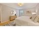 Cozy bedroom featuring a light wood dresser, round mirror, neutral walls, and plush bedding at 1230 Somersby Ln, Matthews, NC 28105
