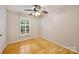 Bedroom with natural light through shuttered windows and hardwood flooring throughout at 1230 Somersby Ln, Matthews, NC 28105