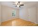 Bedroom featuring hardwood floors, white walls, and a modern ceiling fan at 1230 Somersby Ln, Matthews, NC 28105