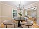 Bright dining area with a round table, stylish chairs, modern lighting and views into the living room at 1230 Somersby Ln, Matthews, NC 28105