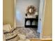 Stylish entryway with a black console table, round mirror, and neutral patterned rug at 1230 Somersby Ln, Matthews, NC 28105