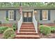Close up shot of the house with brick steps, gray siding, black shutters and black double doors with decorative glass at 1230 Somersby Ln, Matthews, NC 28105