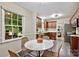 Kitchen with a marble table, seating for four, next to a window at 1230 Somersby Ln, Matthews, NC 28105