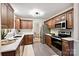 Updated kitchen with granite countertops, stainless steel appliances, and seamless flow to the dining area at 1230 Somersby Ln, Matthews, NC 28105