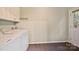 Well-lit laundry room with washer, dryer, and exterior door at 1230 Somersby Ln, Matthews, NC 28105