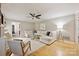 Bright living room with a white sofa and hardwood floors at 1230 Somersby Ln, Matthews, NC 28105