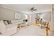 Spacious living room with white sofa, ceiling fan, and hardwood floors at 1230 Somersby Ln, Matthews, NC 28105