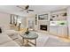 Inviting living room featuring a brick fireplace, built-in shelves, and comfortable seating at 1230 Somersby Ln, Matthews, NC 28105