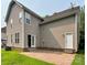 Exterior view of a house showing a patio, lawn, and the back of the house with two entrances at 12904 Windy Lea Ln, Huntersville, NC 28078