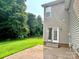 Spacious backyard featuring a well-maintained lawn, patio, and a wooded backdrop at 12904 Windy Lea Ln, Huntersville, NC 28078