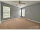 Spacious bedroom featuring neutral walls, carpet flooring, and a ceiling fan at 12904 Windy Lea Ln, Huntersville, NC 28078