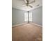Bright bedroom features neutral walls, carpet flooring, and a ceiling fan at 12904 Windy Lea Ln, Huntersville, NC 28078