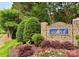 Stone community sign for Crosswinds surrounded by green foliage and colorful red, white, and green manicured ground cover at 12904 Windy Lea Ln, Huntersville, NC 28078
