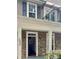 Exterior view of home featuring stone facade, covered porch, balcony, and visible house number at 12904 Windy Lea Ln, Huntersville, NC 28078