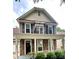 Charming front exterior of a two-story home with stone accents, front porch and balcony at 12904 Windy Lea Ln, Huntersville, NC 28078