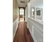 Interior hallway with hardwood floors leading to a kitchen and views to the expansive living area at 12904 Windy Lea Ln, Huntersville, NC 28078