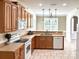 Well-lit kitchen featuring light wood cabinetry, ceramic floors, modern appliances, and ample counter space at 12904 Windy Lea Ln, Huntersville, NC 28078