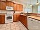 Bright kitchen featuring stainless steel appliances, ceramic floors, and lots of cabinet space at 12904 Windy Lea Ln, Huntersville, NC 28078