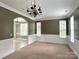 Charming living area with large windows, chandelier lighting, and decorative wainscoting at 12904 Windy Lea Ln, Huntersville, NC 28078