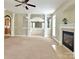 Expansive living room with neutral carpet, fireplace, archways and views to other rooms in the home at 12904 Windy Lea Ln, Huntersville, NC 28078
