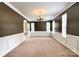 Bright living area featuring natural light, crown molding, and classic wainscoting at 12904 Windy Lea Ln, Huntersville, NC 28078