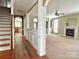 Open-concept interior featuring hardwood, carpet, staircase, fireplace, and views to kitchen and other rooms at 12904 Windy Lea Ln, Huntersville, NC 28078
