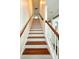 Classic staircase with stained wood treads and white risers, leading to the upper level at 12904 Windy Lea Ln, Huntersville, NC 28078