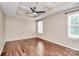 Spacious bedroom with hardwood floors, tray ceiling with ceiling fan and two large windows at 13407 Morgan Lee Ave, Charlotte, NC 28213
