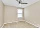 Bright bedroom with neutral walls, a ceiling fan, and large window at 13407 Morgan Lee Ave, Charlotte, NC 28213