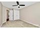 Spacious bedroom featuring a ceiling fan and closet with double doors at 13407 Morgan Lee Ave, Charlotte, NC 28213