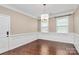 Elegant dining room with hardwood floors, wainscoting and chandelier lighting at 13407 Morgan Lee Ave, Charlotte, NC 28213