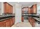Stylish kitchen featuring granite countertops, mosaic backsplash, stainless steel appliances, and tile flooring at 13407 Morgan Lee Ave, Charlotte, NC 28213