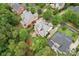 Aerial view of a landscaped yard with a stone patio, outdoor seating, and lush trees in a suburban setting at 13716 Glen Abbey Dr, Charlotte, NC 28278