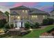 Back exterior showcasing a spacious brick home with a deck, patio, landscaped garden, and outdoor dining at 13716 Glen Abbey Dr, Charlotte, NC 28278